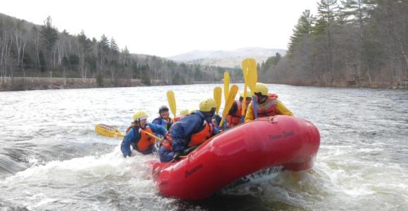 a man riding on a raft in a body of water