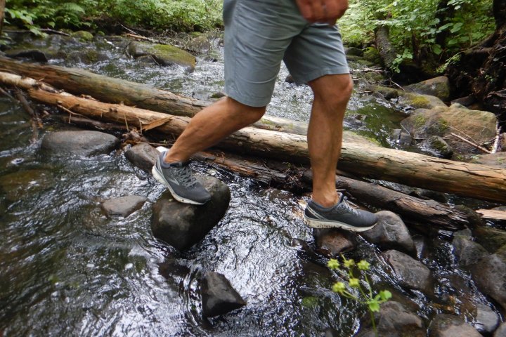 a man standing next to a river